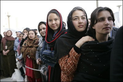 Women stand outside the U.S. Embassy in Kabul, Afghanistan Wednesday, March 1, 2006. President George W. Bush and Laura Bush made a surprise visit to the city and presided over a ceremonial ribbon-cutting at the embassy before continuing their trip to India.