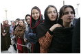 Women stand outside the U.S. Embassy in Kabul, Afghanistan Wednesday, March 1, 2006. President George W. Bush and Laura Bush made a surprise visit to the city and presided over a ceremonial ribbon-cutting at the embassy before continuing their trip to India.