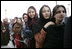 Women stand outside the U.S. Embassy in Kabul, Afghanistan Wednesday, March 1, 2006. President George W. Bush and Laura Bush made a surprise visit to the city and presided over a ceremonial ribbon-cutting at the embassy before continuing their trip to India.