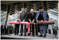 President George W. Bush and Afghanistan President Hamid Karzai, right, cut the ceremonial ribbon, Wednesday, March 1, 2006, to dedicate the new U.S. Embassy Building in Kabul, Afghanistan. President Bush is joined by Mrs. Laura Bush; U.S. Secretary of State Condoleezza Rice and U.S. Ambassador to Afghanistan Ronald E. Neumann.