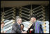 President George W. Bush and Afghanistan President Hamid Karzai shake hands after cutting the ceremonial ribbon, Wednesday, March 1, 2006, to dedicate the new U.S. Embassy Building in Kabul, Afghanistan. President Karzai thanked President Bush and the American people for their continued support to the Afghan people.