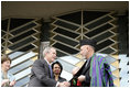 President George W. Bush and Afghanistan President Hamid Karzai shake hands after cutting the ceremonial ribbon, Wednesday, March 1, 2006, to dedicate the new U.S. Embassy Building in Kabul, Afghanistan. President Karzai thanked President Bush and the American people for their continued support to the Afghan people.