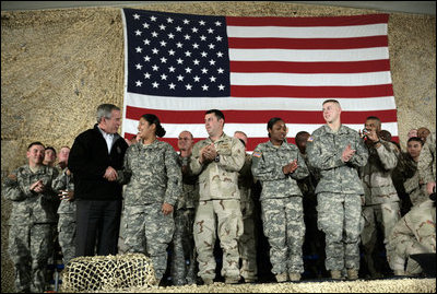 President George W. Bush meets and thanks a group of U.S. and Coalition troops, Wednesday, March 1, 2006, during a visit to Bagram Air Base in Afghanistan, where President Bush thanked the troops for their service in defense of freedom.