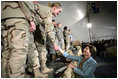 Mrs. Laura Bush greets U.S. and Coalition troops Wednesday, March 1, 2006, during a stopover at Bagram Air Base in Afghanistan, prior to the President and Mrs. Bush visiting India and Pakistan.