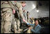 Mrs. Laura Bush greets U.S. and Coalition troops Wednesday, March 1, 2006, during a stopover at Bagram Air Base in Afghanistan, prior to the President and Mrs. Bush visiting India and Pakistan.