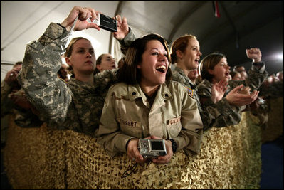 U.S. and Coalition troops cheer and take photos Wednesday, March 1, 2006, during an appearance by President George W. Bush and Mrs. Laura Bush at Bagram Air Base in Afghanistan.