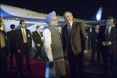 President George W. Bush is welcomed to India by Indian Prime Minister Manmohan Singh upon Air Force One's arrival Wednesday, March 1, 2006, at Indira Gandhi International Airport. The President and First Lady are scheduled to spend three days in the country before flying to Pakistan.