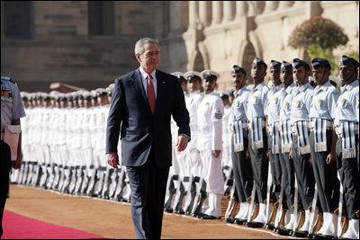 President George W. Bush reviews troops Thursday, March 2, 2006, during the arrival ceremony at Rashtrapati Bhavan, the presidential residence in New Delhi, welcoming he and Laura Bush to India.