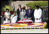 President George W. Bush and Laura Bush are joined by Rajnish Kumar, right, Secretary of the Rajghat Samadhi Committee, and Dr. Nirmila Deshpande, co-Chair of the Rajghat Gandhi Samadhi committee, for a moment of silence at the Mahatma Gandhi Memorial in Rajghat, India on March 2, 2006.