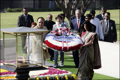 President George W. Bush and Laura Bush participate in a wreath-laying ceremony Thursday, March 2, 2006, in Rajghat, India, at the memorial for Mahatma Gandhi.