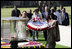 President George W. Bush and Laura Bush participate in a wreath-laying ceremony Thursday, March 2, 2006, in Rajghat, India, at the memorial for Mahatma Gandhi.