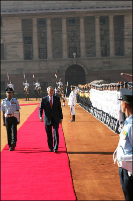 President George W. Bush reviews troops Thursday, March 2, 2006, during the arrival ceremony at Rashtrapati Bhavan, the presidential residence in New Delhi, welcoming he and Laura Bush to India.