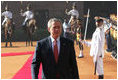 President George W. Bush reviews troops Thursday, March 2, 2006, during the arrival ceremony at Rashtrapati Bhavan, the presidential residence in New Delhi, welcoming he and Laura Bush to India.