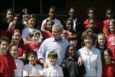 President George W. Bush and Laura Bush pose with students at the College Park Elementary School in Gautier, Miss., Wednesday, March 8, 2006, where Mrs. Bush announced the establishment of The Gulf Coast School Library Recovery Initiative, to help Gulf Coast schools that were damaged by the hurricanes rebuild their book and material collections. The initiative was established by the Laura Bush Foundation for American Libraries.