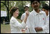 Mrs. Laura Bush signs the jerseys of students from the Schola Nova school and the Islamabad College for Boys, Saturday, March 4, 2006, who participated in a cricket clinic with President George W. Bush at the Raphel Memorial Gardens on the grounds of the U.S. Embassy in Islamabad, Pakistan.