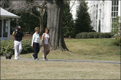 Mrs. Laura Bush takes a brisk walk with Barbara Harrison of WRC-TV (NBC 4) around the South Grounds of the White House Friday, March 10, 2006, during an interview given by Mrs. Harrison. The focus of the interview is to promote exercise and health awareness.