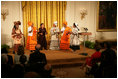 Mrs. Laura Bush listens to a performance from members of the Mothers to Mothers-To-Be representatives of South Africa, Monday, March 13, 2006 in the East Room of the White House. Mrs. Bush had earlier met with the members of the program, who mentor and counsel mothers who come for prenatal care to clinics and find they are HIV-positive, on her visit to South Africa in July of 2005. From left to right on stage are Aunt Manyongo "Kunene" Mosima Tantoh, Nosisi Mngceke, Patty Thomas, Gloria Ncanywa, Monica Abdullah and Babalwa Mbono.