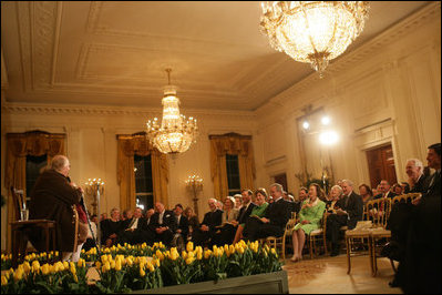 President George W. Bush and Mrs. Laura Bush join their invited guests in listening to Benjamin Franklin interpreter, Ralph Archbold of Philadelphia, Pa., Thursday evening, March 23, 2006 in the East Room of the White House, during a Social Dinner to honor the 300th birthday of Benjamin Franklin.