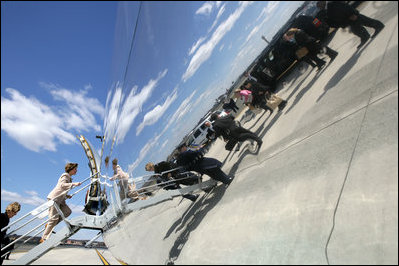 Mrs. Laura Bush and members of her staff are reflected along the side of her aircraft, Thursday, March 16, 2006, as they depart Newark LIberty International Airport en route to Andrews AFB. Mrs. Bush visited the Avon Ave Elementary School in Newark to announce a Striving Readers grant to Newark Public Schools, to support programs to improve students reading skills.