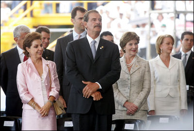 Laura Bush stands next to President Vicente Fox and his wife Marta Sahagun de Fox of Mexico during the inaugural ceremony of President Oscar Arias at the Estadio Nacional in San Jose, Costa Rica, Monday, May 8, 2006.