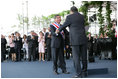 President Oscar Arias is embraced by outgoing President Abel Pacheco during the inaugural at the Estadio Nacional in San Jose, Costa Rica, Monday, May 8, 2006.