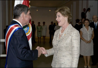 After the inauguration ceremony, Mrs. Laura Bush greets President Oscar in San Jose, Costa Rica, Monday, May 8, 2006. "Today I had the opportunity to convey to President Arias the United States' strong support and partnership with Costa Rica," said Mrs. Bush in a statement to the press. "We have a history of a long friendship, and I'm very, very happy to have been the one to get to give him the very best wishes of the American people."