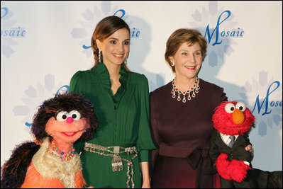 Mrs. Laura Bush stands with Her Majesty Queen Rania Al-Abdullah of Jordan and Sesame Street characters Khokha, left, and Elmo during a dinner celebrating the partnership between the Sesame Workshop and the Mosaic Foundation at the National Building Museum in Washington, D.C., Wednesday, May 9, 2006. Founded by the spouses of Arab Ambassadors to the United States, the Mosaic Foundation is dedicated to improving the lives of women and children.