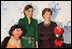 Mrs. Laura Bush stands with Her Majesty Queen Rania Al-Abdullah of Jordan and Sesame Street characters Khokha, left, and Elmo during a dinner celebrating the partnership between the Sesame Workshop and the Mosaic Foundation at the National Building Museum in Washington, D.C., Wednesday, May 9, 2006. Founded by the spouses of Arab Ambassadors to the United States, the Mosaic Foundation is dedicated to improving the lives of women and children.