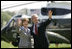 President George W. Bush and Mrs. Laura Bush wave to guests on the South Lawn Friday, May 12, 2006, before boarding Marine One en route Camp David.