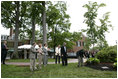 President George W. Bush and Australian Prime Minister John Howard participate in the presentation of White House trees at the Australian Ambassador's Residence, Sunday, May 14, 2006.