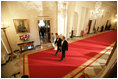 President George W. Bush and Laura Bush walk with Australian Prime Minister John Howard and his wife Mrs. Janette Howard through the Cross Hall as they arrive for the official dinner held in honor of the Prime Minister Tuesday, May 16, 2006.