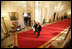 President George W. Bush and Laura Bush walk with Australian Prime Minister John Howard and his wife Mrs. Janette Howard through the Cross Hall as they arrive for the official dinner held in honor of the Prime Minister Tuesday, May 16, 2006.