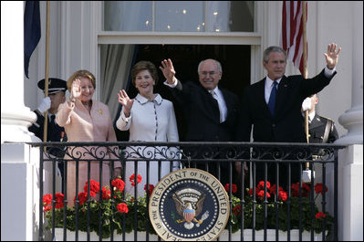 President George W. Bush, Prime Minister John Howard, Mrs. Laura Bush and Mrs. Janette Howard wave from the South Portico of the White House during the State Arrival Ceremony on the South Lawn Tuesday, May 16, 2006.