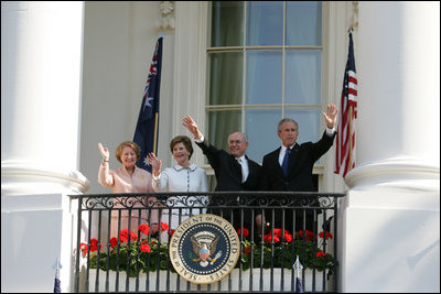 President George W. Bush, Prime Minister John Howard, Mrs. Laura Bush and Mrs. Janette Howard wave from the South Portico of the White House during the State Arrival Ceremony on the South Lawn Tuesday, May 16, 2006.