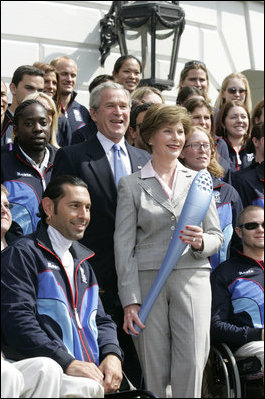 President George W. Bush and Laura Bush, seen holding an Olympic torch, pose with the 2006 U.S. Winter Olympic and Paralympic teams during a congratulatory ceremony held on the South Lawn at the White House Wednesday, May 17, 2006.