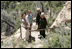 Mrs. Laura Bush pauses for a photo while hiking in Mesa Verde National Park in Colorado with, from left, Lynn Scarlett, Acting Secretary of the U.S. Department of Interior, Fran Mainella, Director, National Park Service and Larry Wiese, Superintendent of Mesa Verde National Park on Tuesday, May 23, 2006. Mesa Verde, founded as a national park on June 29, 1906, is celebrating its Centennial Anniversary this year.