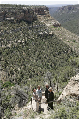 Mrs. Laura Bush pauses for a photo while hiking in Mesa Verde National Park in Colorado with, from left, Lynn Scarlett, Acting Secretary of the U.S. Department of Interior, Fran Mainella, Director, National Park Service and Larry Wiese, Superintendent of Mesa Verde National Park on Tuesday, May 23, 2006. Mesa Verde, founded as a national park on June 29, 1906, is celebrating its Centennial Anniversary this year.