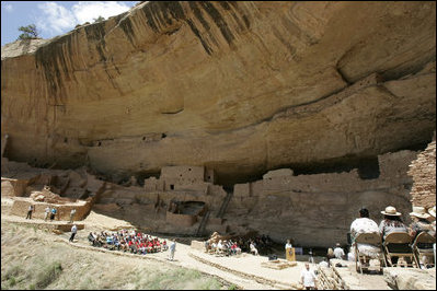 Mrs. Laura Bush talks to a crowd, Thursday, May 23, 2006, assembled in Long House cliff dwellings during a celebration of the 100th anniversary of Mesa Verde and the Antiquities Act in Mesa Verde, Colo. Mesa Verde was the first national park established to protect America's man-made treasures; and Long House is the second largest cliff dwelling in the park.