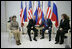 President George W. Bush and Russia's President Vladimir Putin exchange handshakes Wednesday, Nov. 15, 2006, as Mrs. Laura Bush and Lyudmila Putina look on. The brief Moscow stop was the first on the President and First Lady's week-long trip.