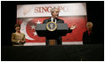 President George W. Bush addresses U.S. embassy staff and families during an embassy greeting in Singapore Thursday, November 16, 2006. U.S. Ambassador Patricia Herbold is pictured at the right.