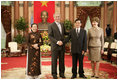 President George W. Bush and Mrs. Laura Bush join Viet President Nguyen Minh Triet and Mrs. Tran Thi Kim Chi in the Great Hall of the Presidential Palace Friday, Nov. 17, 2006, after arriving in Hanoi for the 2006 APEC Summit.