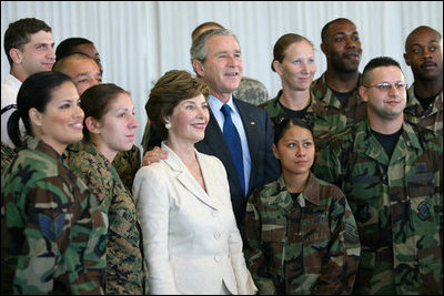 President George W. Bush and Laura Bush pose for photos with military personnel during a breakfast Tuesday, Nov. 21, 2006, at the Officers Club at Hickam Air Force Base in Honolulu, Hawaii.