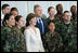 President George W. Bush and Laura Bush pose for photos with military personnel during a breakfast Tuesday, Nov. 21, 2006, at the Officers Club at Hickam Air Force Base in Honolulu, Hawaii.