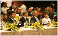 President George W. Bush and Mrs. Laura Bush enjoy the APEC gala dinner and cultural performance Saturday, Nov. 18, 2006, at the National Convention Center in Hanoi. They are seated with President Vladimir Putin of Russia, and President Roh Moo-hyun of the Republic of Korea, left, and Prime Minister Helen Clark of New Zealand, right.