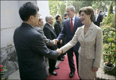 Mrs. Laura Bush is greeted as she and President George W. Bush arrive for church services Sunday, Nov. 19, 2006, at Cua Bac Church in Hanoi.