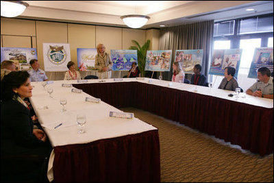 Mrs. Laura Bush is introduced by Mary Fallon, right, wife of Navy Admiral William J. Fallon the Commander of the U.S. Pacific Command, during a roundtable discussion with military personnel Tuesday, Nov. 21, 2006, on military housing and educational services provided to families stationed in Honolulu, Hawaii.