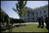 President George W. Bush and Laura Bush take part in the planting of three elm trees on the north grounds of the White House Monday, Oct. 2, 2006. The trees, cultivated by the National Park Service, replace trees recently lost to age, winds and Dutch elm disease. The new trees were grown to be resistant to the disease.