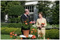 Mrs. Laura Bush smiles at Bill Williams, President and CEO of Harry & David Holdings, Monday, October 2, 2006, as she participates in a ceremony for the unveiling of the Laura Bush rose in The First Lady's Garden at The White House. Founded in 1872, Jackson & Perkins is a leading hybridizer of garden roses and has launched The Laura Bush rose as part of the First Ladies Rose Series. The rose is a floribunda rose and has light yellow buds that open to a smoky coral color with yellow on the reverse petal.