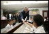 President George W. Bush greets students during a tour of the Laura Bush Library at George W. Bush Elementary School in Stockton, Calif., Tuesday, Oct. 3, 2006.