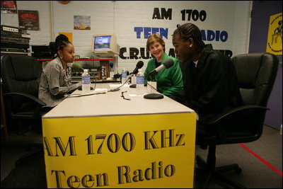 Mrs. Laura Bush participates in a radio interview with Amber Bellamy, age 17, left, and Elliott White, Jr., age 22, Wednesday, October 4, 2006, during a visit to the Children's Training Network/AM 1700 Radio Program in Buffalo, New York, as part of the President's Helping America's Youth initiative. Together with Crucial Human Service Center and other Buffalo community programs, AM 1700 Station encourages caring adults to connect as mentors with high-risk youth.